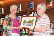 Sue Johnson, the Big Read winner gets the prize from Barbara Boothe